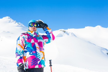 Young man with skis and a ski wear