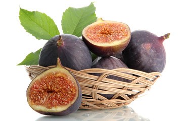 Ripe sweet figs with leaves in basket isolated on white