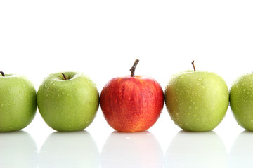 Ripe green apples and one red apple isolated on white