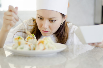 Cute chef pouring sauce on a dish