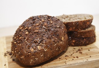 Black bread slices with seeds on a hogger