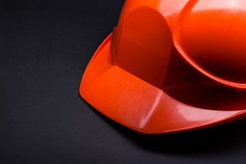 Red safety helmet on black