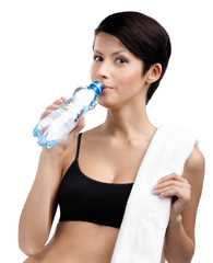 Athletic lady with bottle of water and bath towel