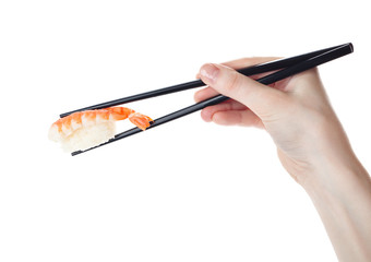 Hand holds the sushi with chopsticks, isolated