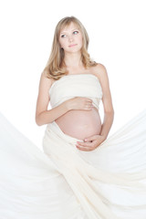 Young beautiful pregnant woman in white sheet