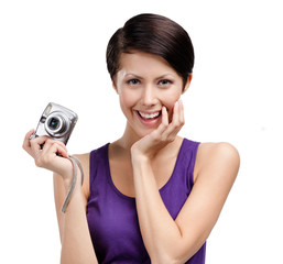 Girl holds amateur hand-held  silver camera, isolated on white