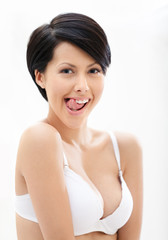 Portrait of woman in underwear putting out a tongue