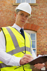 Construction professional with clipboard, an inspector, surveyor - 44379022