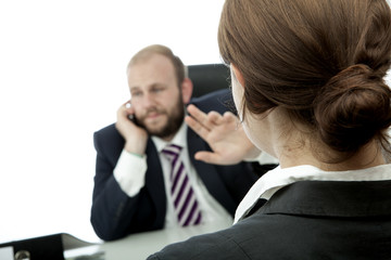 business man and woman at desk sign quiet on phone