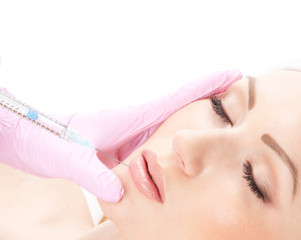 Portrait of a young woman laying on a botox injection procedure