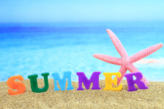 Summertime. The word summer on the beach
