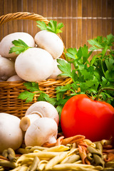 Wicker basket full of fresh champignon mushrooms