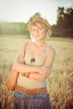 Image of young woman on wheat field 
