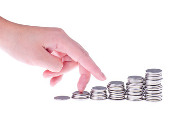 Hand and growing stack of coins