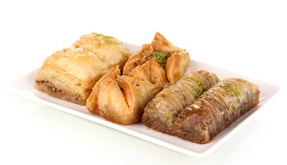 Sweet baklava on plate isolated on white