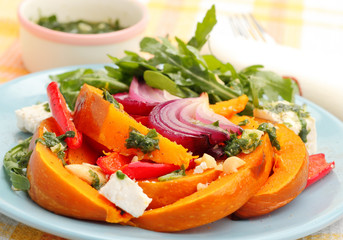 Pumpkin salad with arugula, feta cheese and pesto