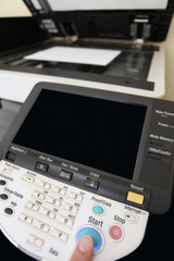 Finger pressing of keyboard buttons of the laser copier