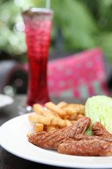 Sausage with potato on wood background