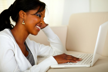 Pretty woman browsing the Internet on laptop