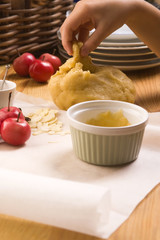Detail of child hands making apple pie