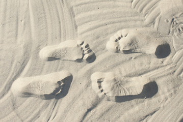 Fototapeta na wymiar Couple steps on the sand