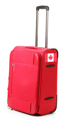 red suitcase with sticker with flag of Canada isolated on white