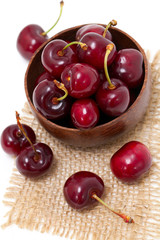cherry in a wooden bowl on sackcloth