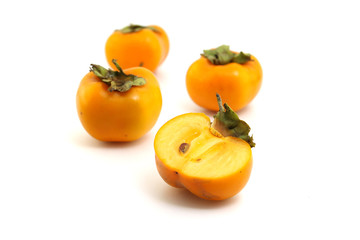 Half of persimmon fruits on white background