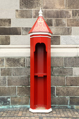 Old red shed with golden monogram at street in Copenhagen