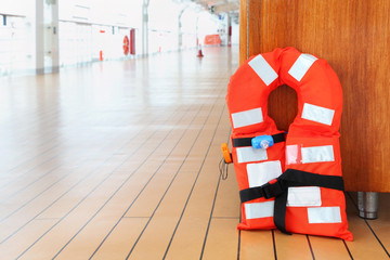 Singular life jacket stands on deck of cruise passenger liner
