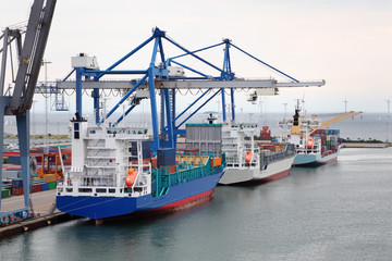 Naklejka premium Three cargo ships in Copenhagen seaport, Denmark