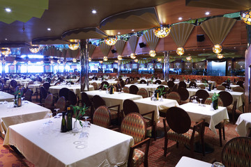 Rows of chairs and tables with white tablecloth