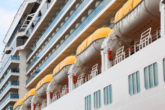 Row of lifeboats installed on beautiful white passenger liner