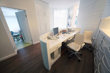 Empty lit reception area in dental clinic.