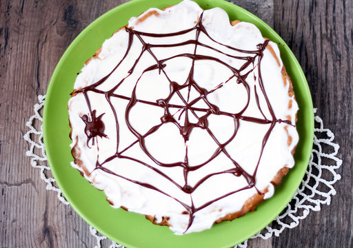 Date and chocolate cake with Halloween decoration - spider web