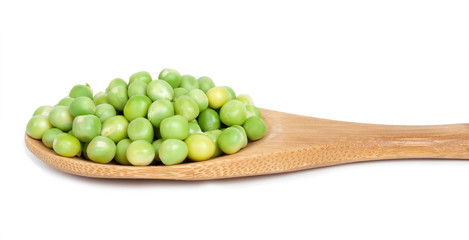 Green peas in wooden spoon