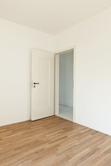 open door in a room with parquet