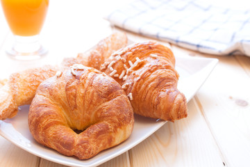 Brioches and orange juice for breakfast
