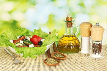 tasty greek salad on bright green background