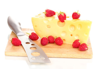 tasty cheese and berries on wooden board isolated on white