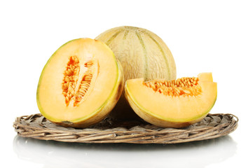 cut melon on wicker mat isolated on white