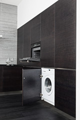 Build-in washing machine and cooker on modern black kitchen