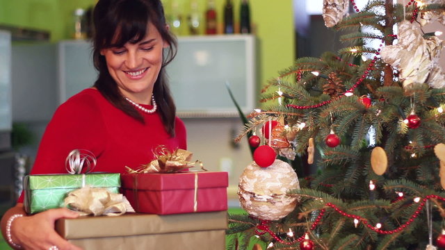 Portrait of smiling young woman with christmas gifts
