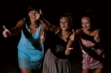 Three beautiful girls on a black background