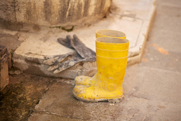 Yellow work boots and gloves