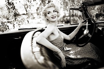 Smiling retro woman in convertible