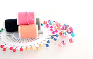 beads, pin, thread on white background
