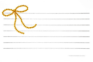 Gold bow on notepaper
