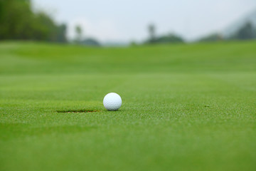 White golf ball near hole
