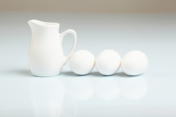 Fototapeta na wymiar Milk in a glass jar and eggs